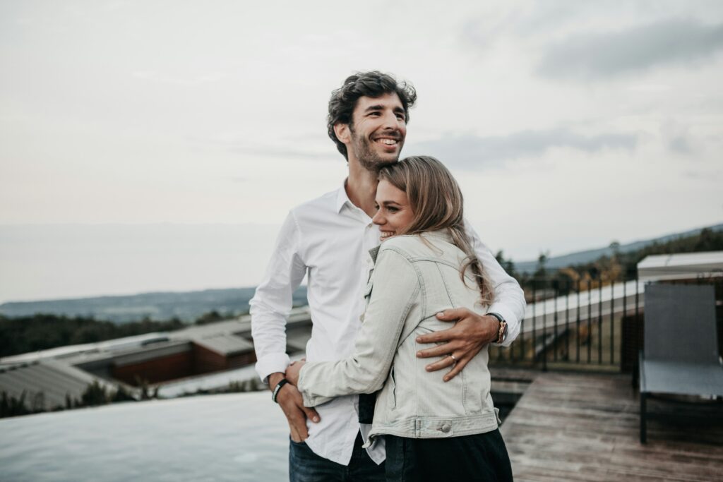 couple embracing outdoors smiling — marriage counseling utah builds deeper connection