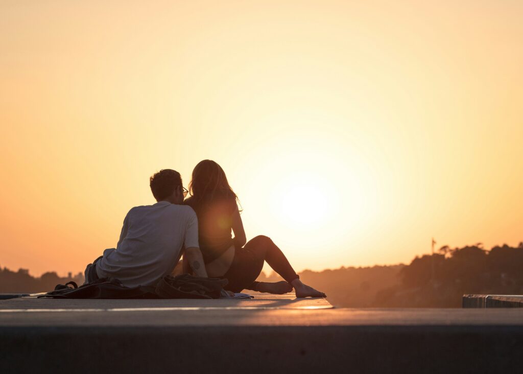 couple sitting together at sunset — marriage counseling utah helps couples repair and rebuild